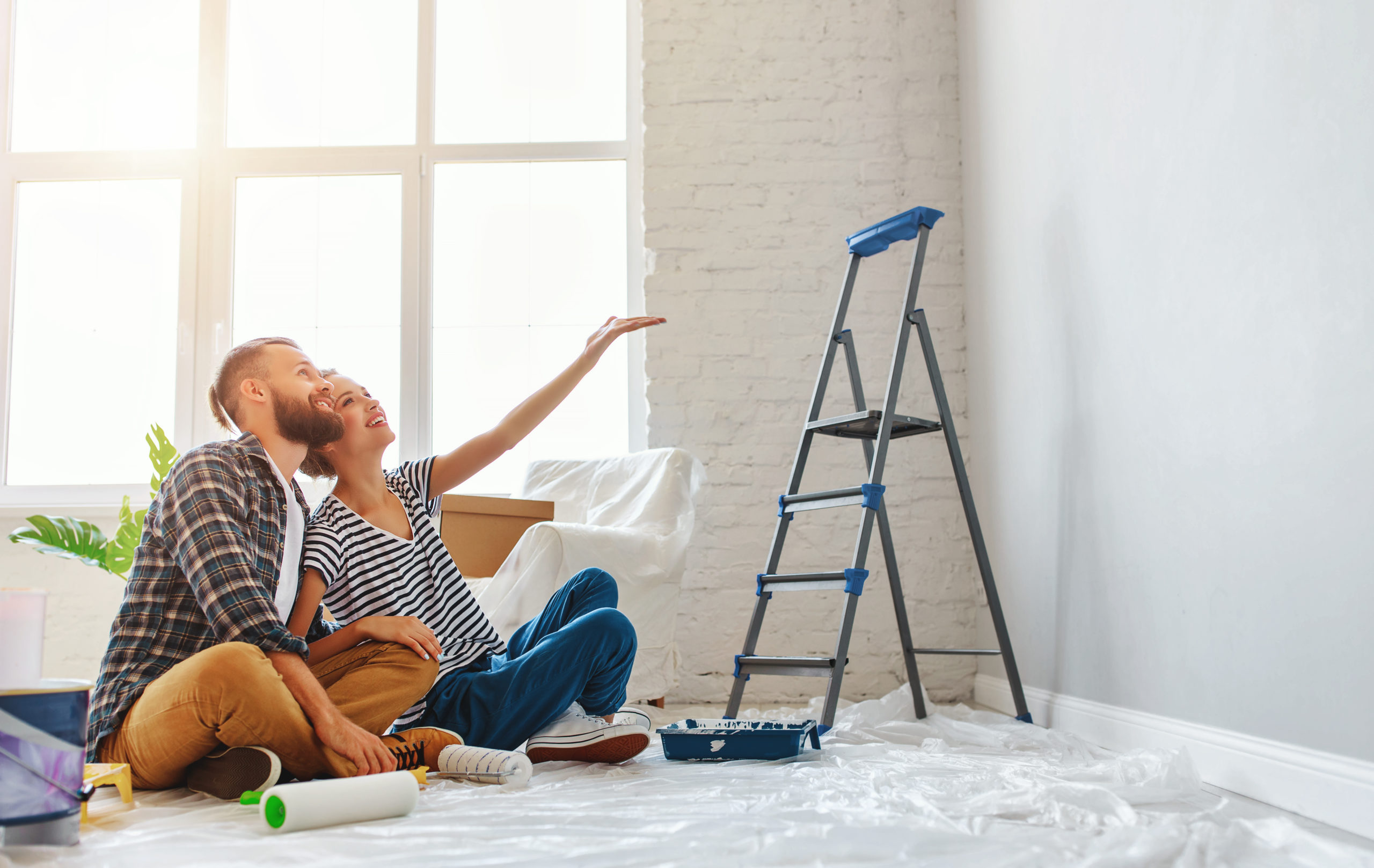 young happy family married couple dreams of renovating  house and planning a design project